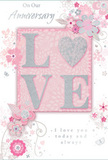 This anniversary card design feels like a whispered promise, rendered in soft pastel pinks, pearly whites, and silvery greys that bring to mind early spring in Richmond upon Thames. At the heart of the card, the word LOVE stands proudly in raised, glitter-trimmed letters, the gentle embossing making each stroke slightly elevated and inviting to touch. The letter O is transformed into a shimmering heart, filled with textured silver that glows softly against the blush background, like twilight catching the surface of the Thames. Around this central word, clusters of delicate flowers in blush, mauve, and pale ivory unfold with a watercolour softness, their edges fading lightly into the card so they seem almost to float. Fine, flowing lines trace out slender stems, tiny leaves, and curling tendrils, intertwining like the stems in a hand-crafted bouquet. Subtle butterflies and tiny swirling flourishes peek out between petals, adding a sense of motion and gentle whimsy, as though a light breeze is passing through an English spring garden. Above and below, the texts On Our Anniversary and I love you today and always appear in an elegant, understated script, complementing rather than crowding the floral artwork. The whole composition feels balanced and thoughtful, the kind of card you might pair with a soft, romantic bouquet delivered to a home near Richmond Green or by the park. It captures the intimacy of long-shared days, offering a tender way to mark another year of walking side by side.